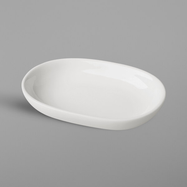 A RAK Porcelain ivory oval dish on a gray surface.