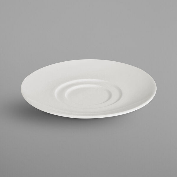A RAK Porcelain ivory porcelain saucer with a circular pattern.