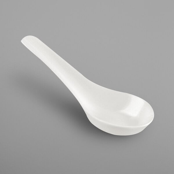A close-up of a white RAK Porcelain spoon with a white bowl and handle.