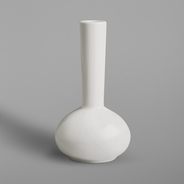A close up of a white RAK Porcelain flower vase with a long neck.