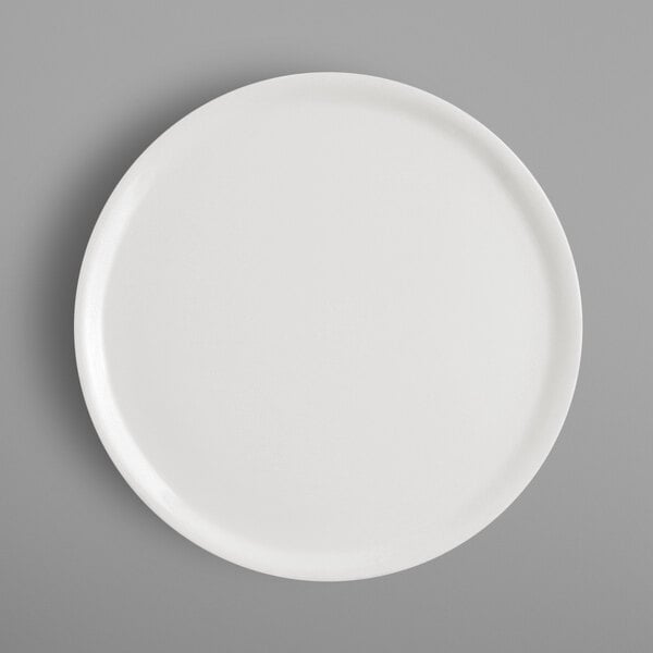 A RAK Porcelain ivory pizza plate on a gray background.