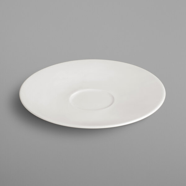 A white RAK Porcelain saucer with a small circle on it.