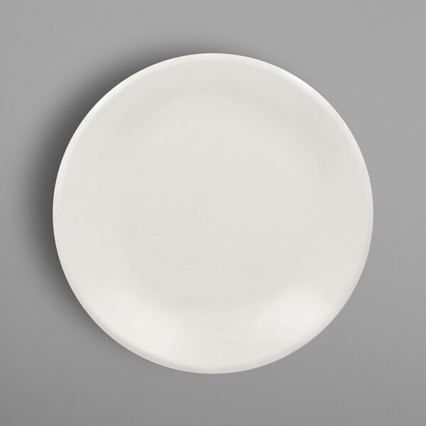 A RAK Porcelain ivory porcelain pizza plate on a gray background.