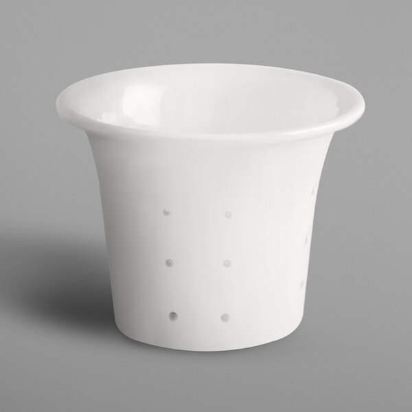 A white porcelain strainer with a handle.