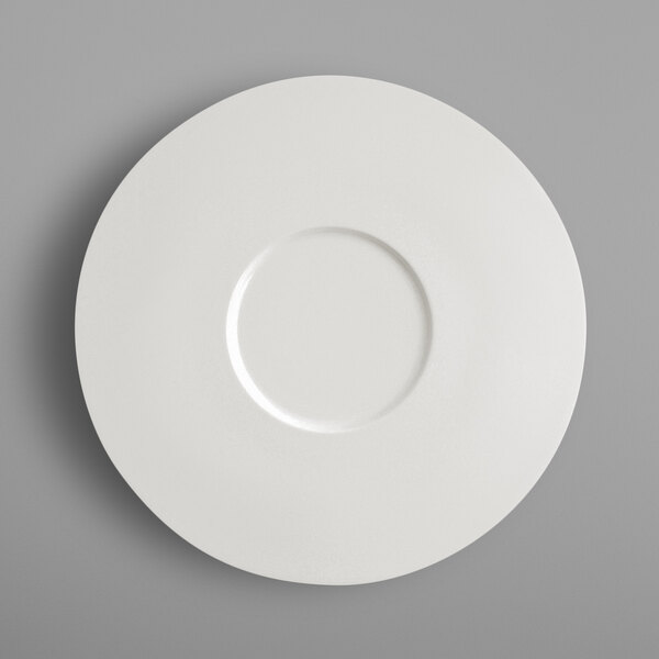 A RAK Porcelain ivory porcelain flat plate with a circle in the middle.