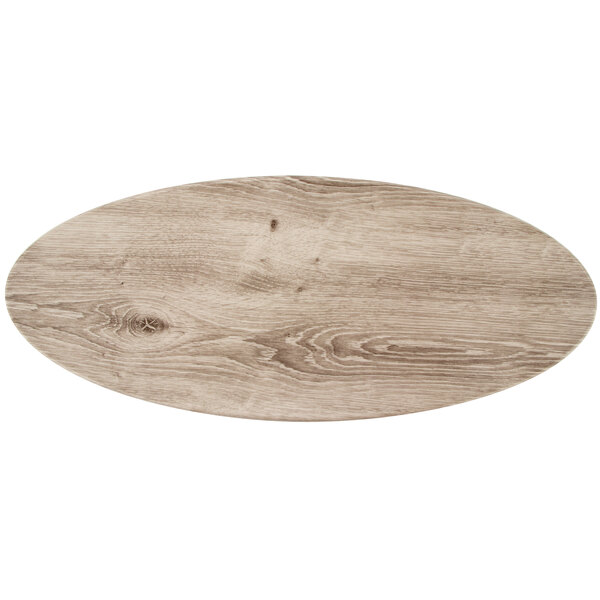 A wood grained oval serving platter with a white background.