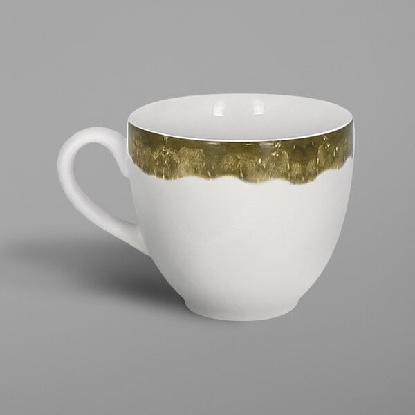 A white porcelain coffee cup with a moss green interior and gold trim.
