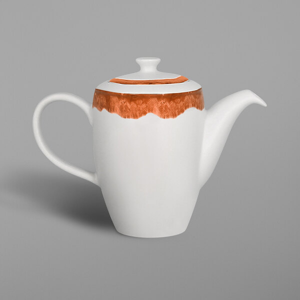 A white porcelain teapot with a brown and orange Woodart design on the handle.