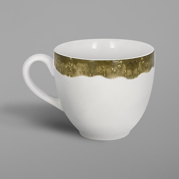 A white porcelain cup with a moss green interior and gold trim.