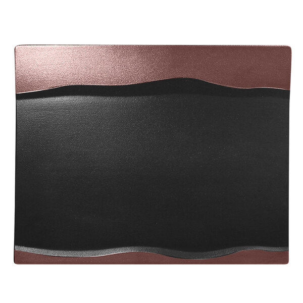 A black and bronze rectangular porcelain platter with a wave design on a black and brown leather pad.