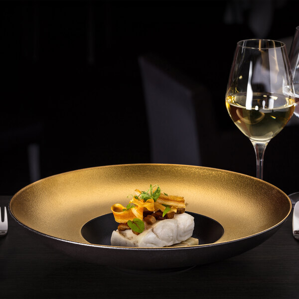 A RAK Porcelain gourmet deep plate with food on a table