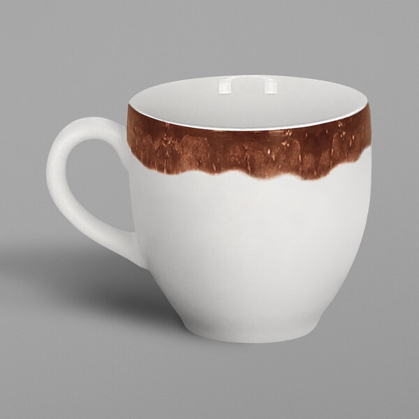 A white porcelain espresso cup with a walnut brown paint design on it.