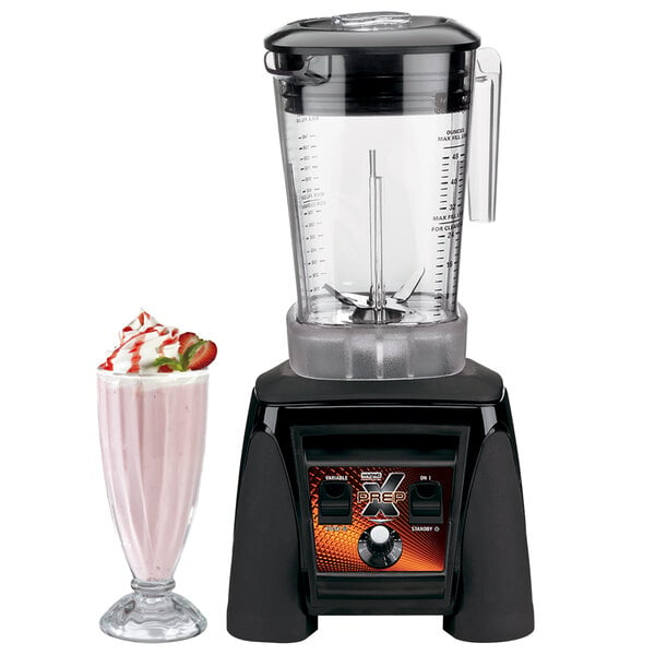A Waring commercial blender with a pink milkshake in a glass.