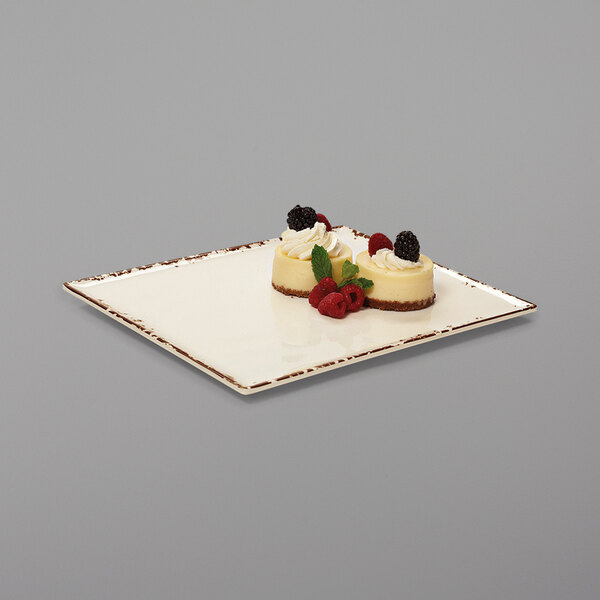 A rectangular white melamine platter with desserts on it.