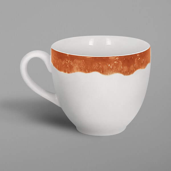 A white porcelain coffee cup with a brown rim and orange and white accents.