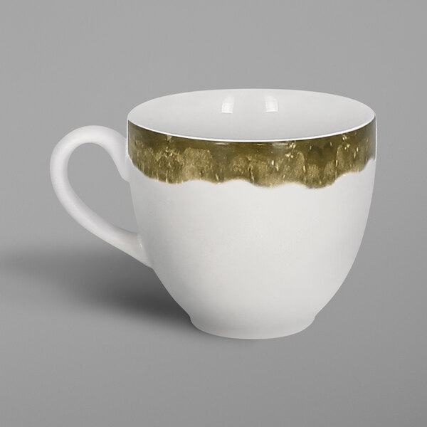 A white porcelain coffee cup with a moss green interior and white handle with gold trim.