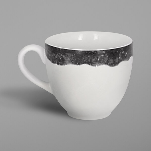 A white porcelain coffee cup with a black and white beech design on the outside.