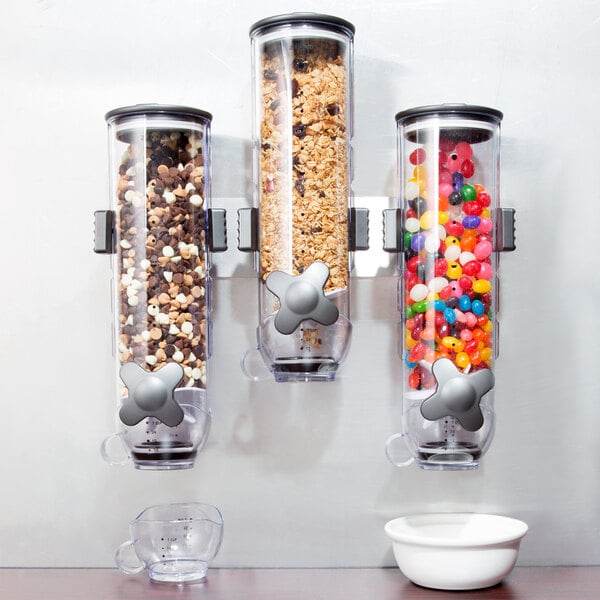 A Zevro SmartSpace triple wall mount dry food dispenser with cereals and beans in it.