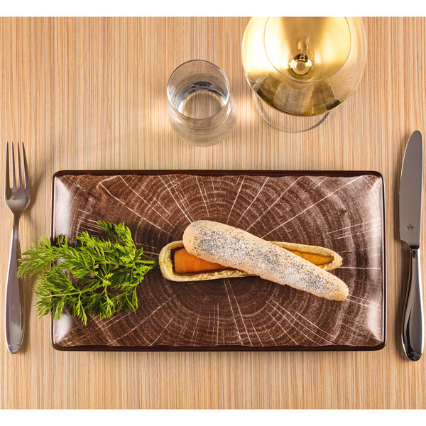 A RAK Porcelain rectangular oak brown porcelain serving platter with bread and a knife on it.