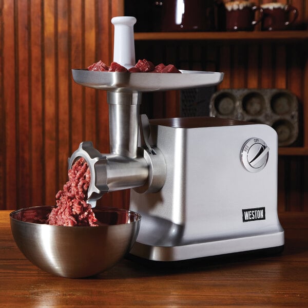 Ground meat in a bowl on a Weston meat grinder.