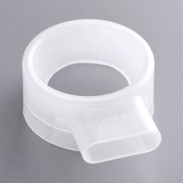 A white plastic steam collector ring with a hole in it.