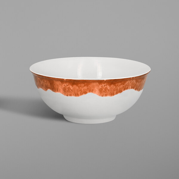 A white RAK Porcelain bowl with a brown and orange design.