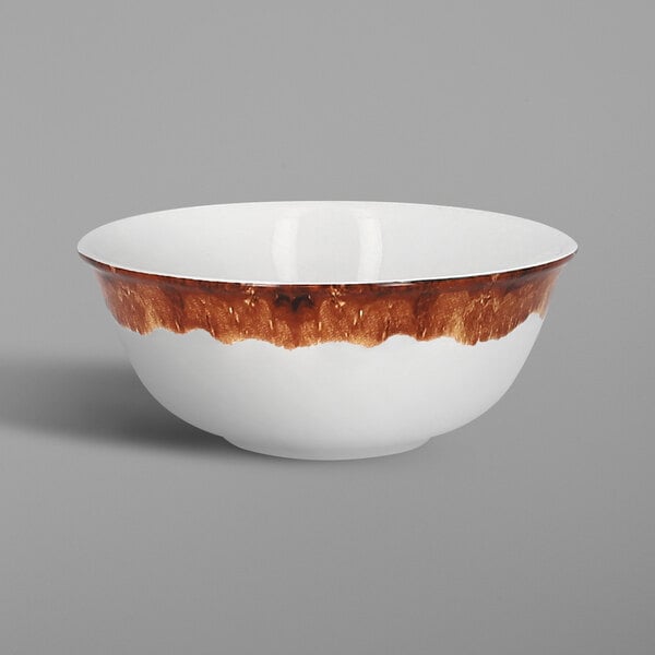 A white porcelain bowl with brown wood-like paint on the rim.
