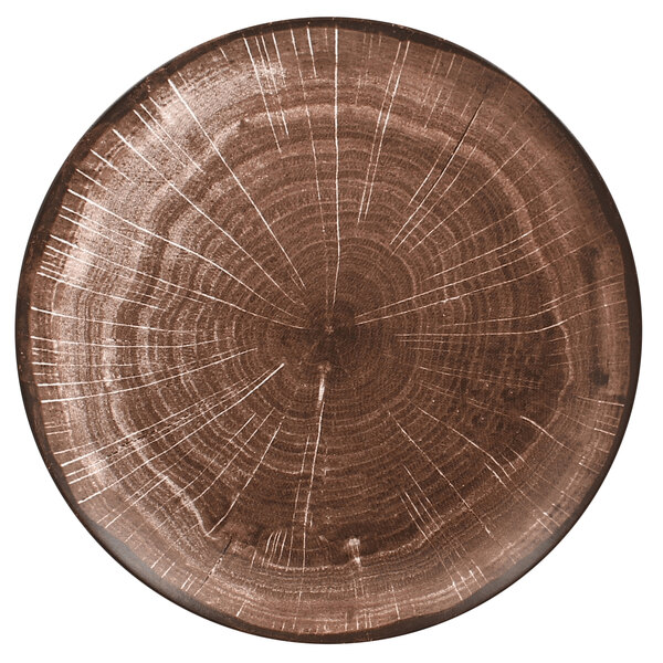 A RAK Porcelain Woodart Oak Brown flat porcelain coupe plate with a tree trunk design.