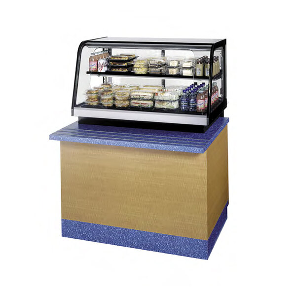A Federal Industries countertop display case with food on it.