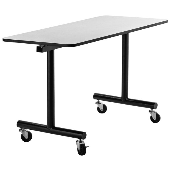 A National Public Seating mobile cafeteria table with a black and white top and wheels.