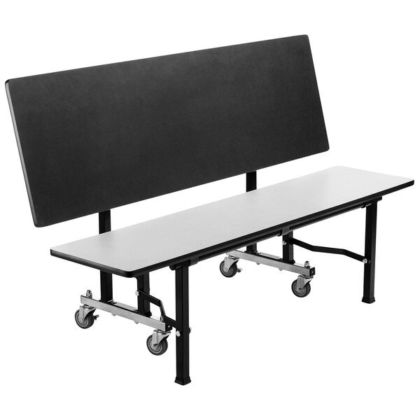 A white and black National Public Seating ToGo mobile bench with wheels.