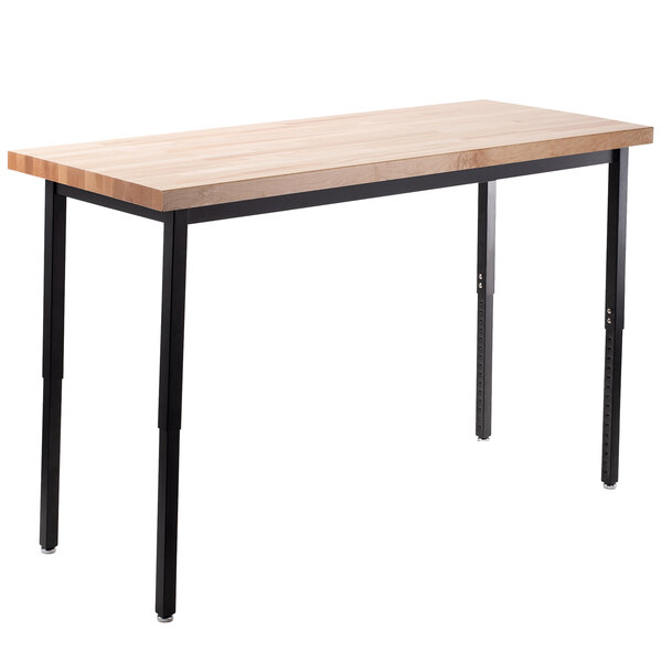 A National Public Seating adjustable height utility table with black legs and a wooden top.