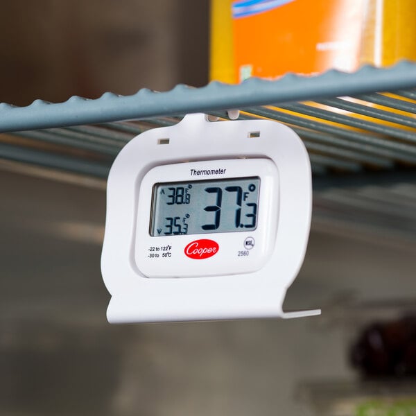 A Cooper Atkins 2560 digital refrigerator / freezer thermometer on a shelf.