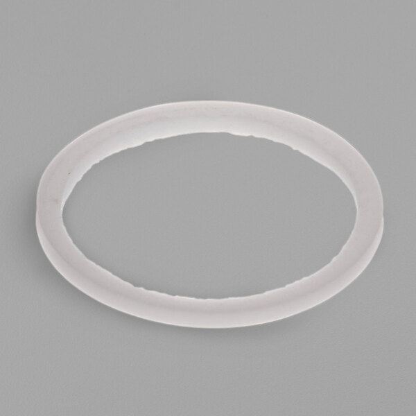 A white plastic oval washer with a hole in it.