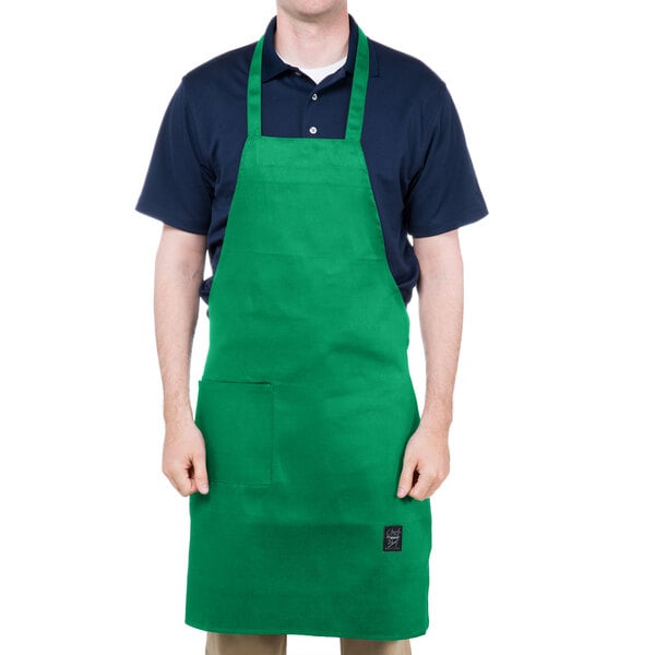 A man wearing a Chef Revival kelly green bib apron with one pocket.