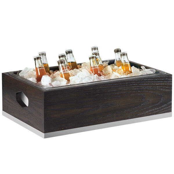 A wooden ice housing with a polycarbonate pan filled with bottles of liquid.