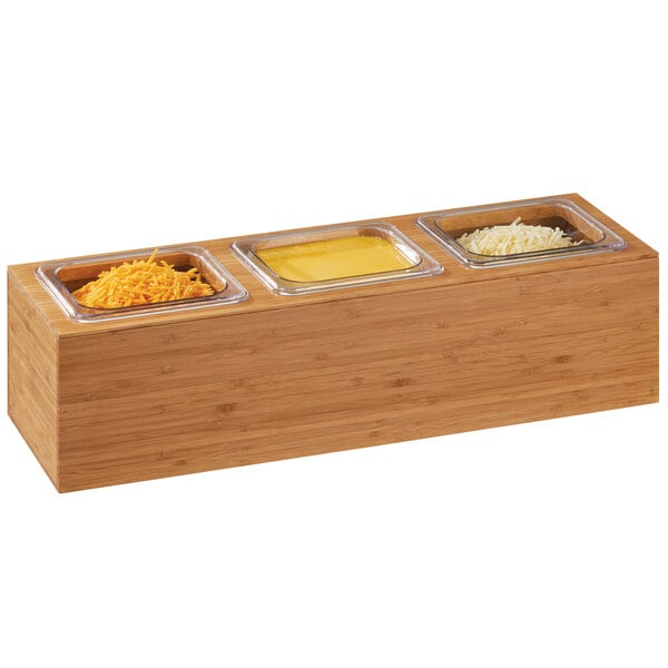 A Cal-Mil bamboo container with 1/6 size pans of different food on a table in a salad bar.