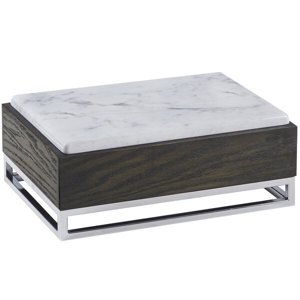 A white marble and wood rectangular riser with a metal base.