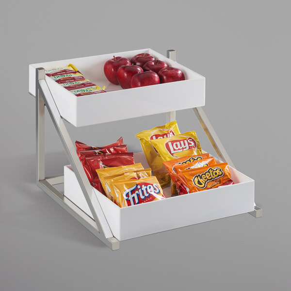 A white Cal-Mil merchandiser shelf with food and snacks on it.