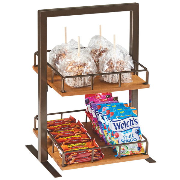 A wooden 2-tier Cal-Mil Sierra merchandiser filled with food on a hotel buffet shelf.