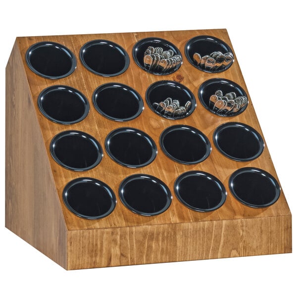 A wooden Cal-Mil Madera display with black circles holding utensils.