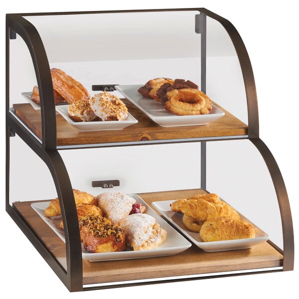 A Cal-Mil Sierra 2-tier display case with pastries on it.