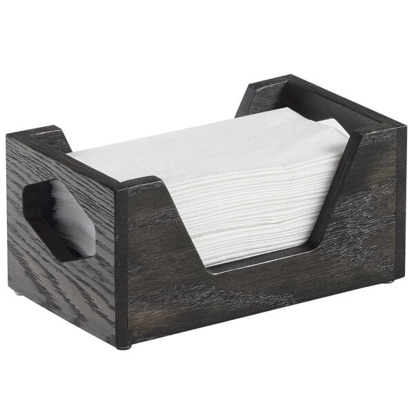A wooden Cal-Mil Cinderwood napkin holder with a white napkin.
