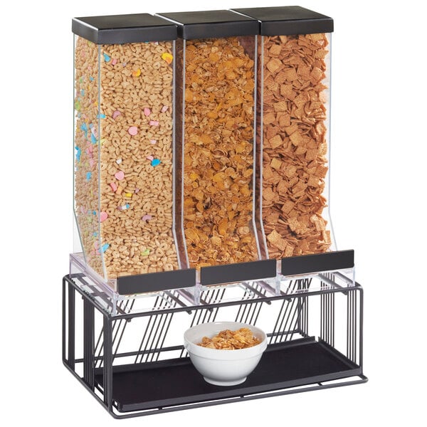 A black Cal-Mil triple cereal dispenser with bowls of cereal.