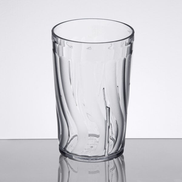 A clear Dinex plastic tumbler with a swirl pattern.