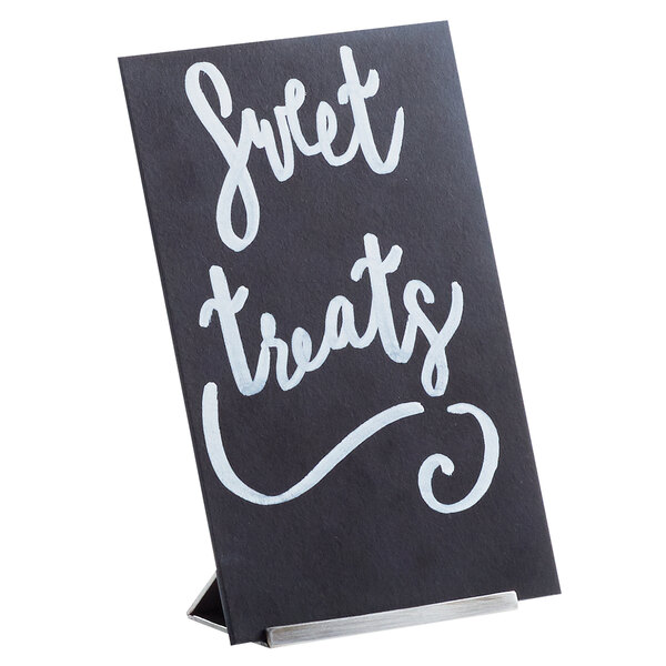 A white Cal-Mil open frame chalkboard sign with black text that says sweet treats.