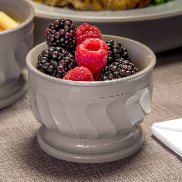 A Dinex Turnbury latte bowl filled with raspberries and blackberries on a table.