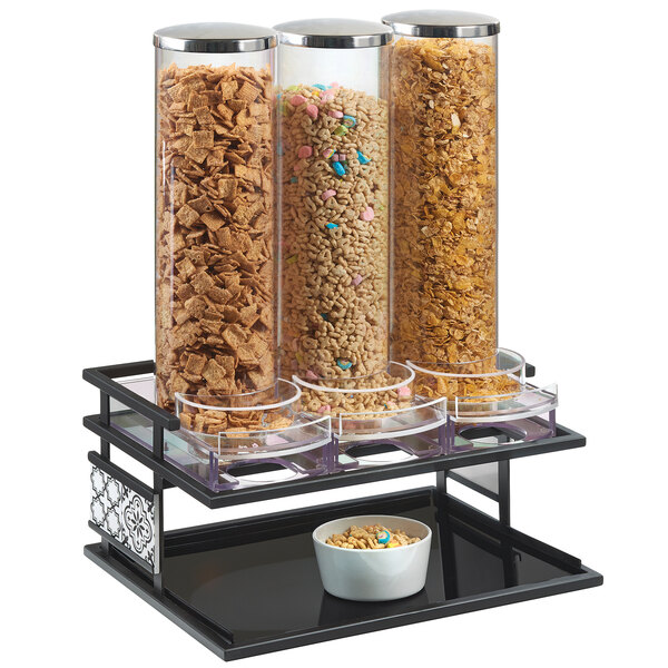 A black Cal-Mil Granada triple cereal dispenser on a table with bowls of cereal.