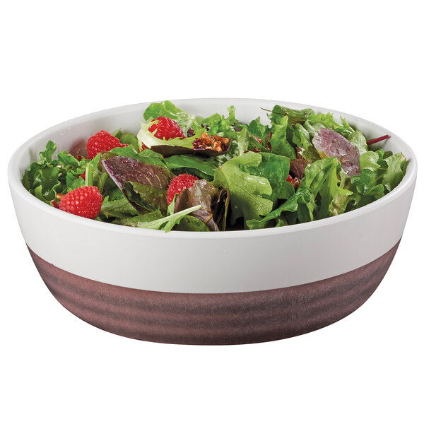 A white Cal-Mil melamine stoneware bowl filled with salad and greens with raspberries.