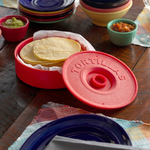 A stack of tortillas in a red container with a red lid.